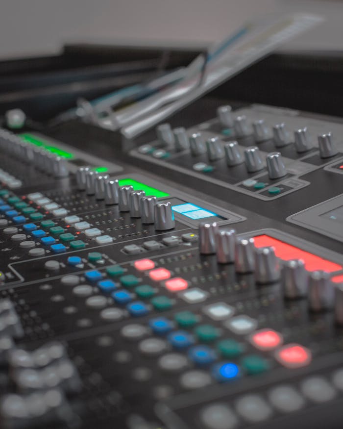 services-03 Detailed view of a modern audio mixing console with colorful LED indicators, ideal for sound engineering.